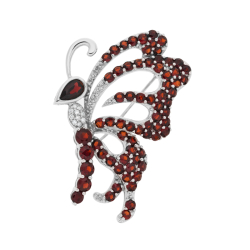 Brož z bílého zlata s granáty a diamanty. Rozměr 4,50 x 3,00cm