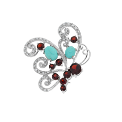 Brož z bílého zlata s granáty, tyrkysy a diamanty. Rozměr 3,90 x 3,50cm